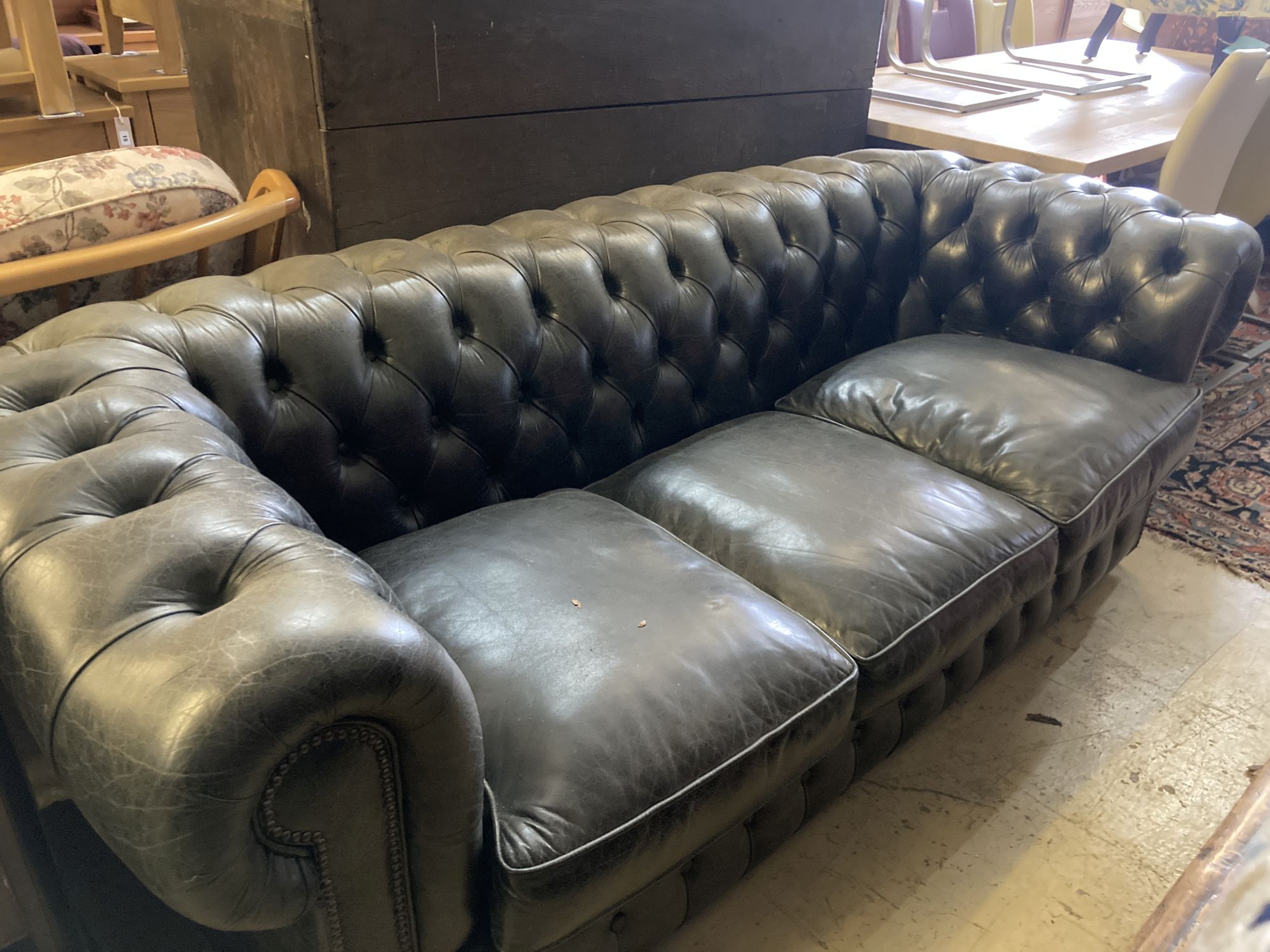 A Fleming & Howland, Chesterfields buttoned black leather three seater Chesterfield settee, length 200cm, depth 86cm, height 74cm